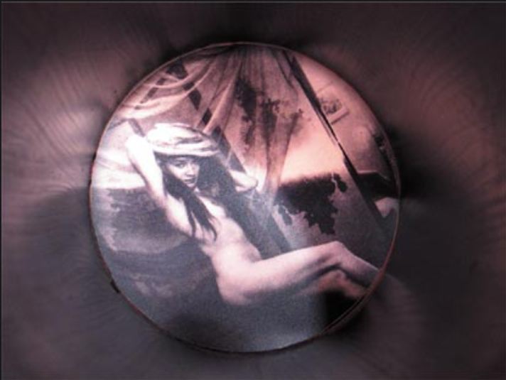 the polaroid of carlo mollino is presented inside the metal tube for the expossition Mollino fragments, Triennale de Milan, 2005